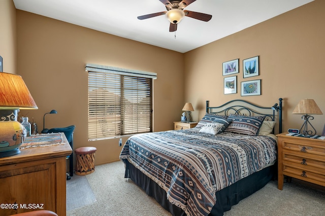 bedroom with light carpet and ceiling fan