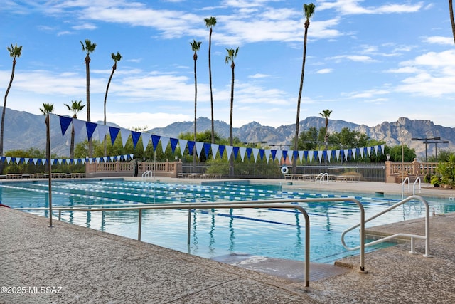 view of swimming pool with a mountain view