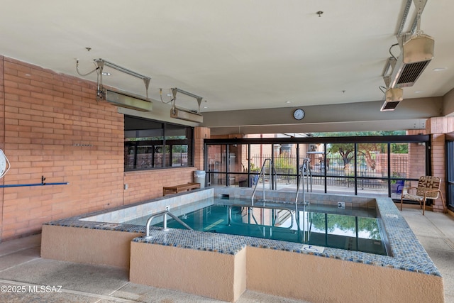 view of pool with an indoor hot tub