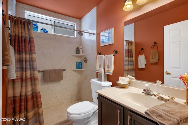 bathroom with vanity, a shower with shower curtain, and toilet