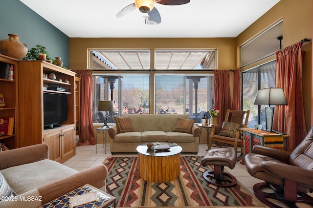 living room featuring light tile patterned floors and ceiling fan