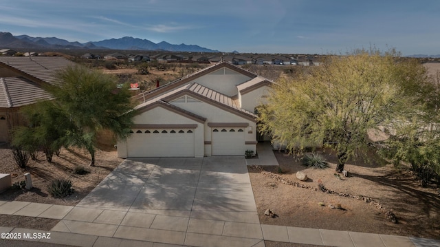 view of front of house featuring a garage and a mountain view