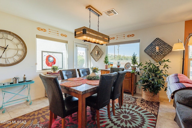 dining area with light tile patterned floors