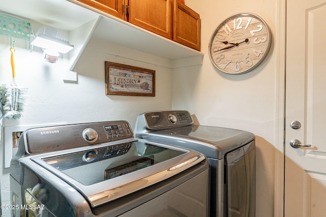 washroom featuring cabinets and washer and dryer