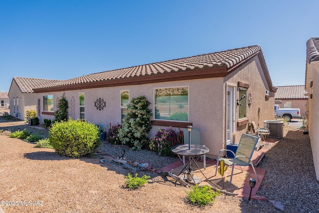 view of property exterior featuring central AC and a patio area