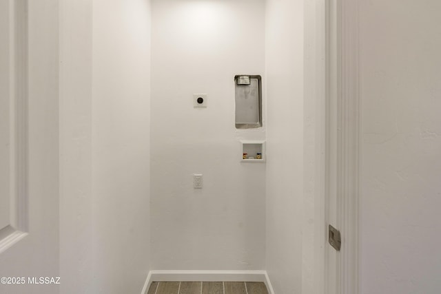 clothes washing area featuring hookup for a washing machine, hookup for an electric dryer, and hardwood / wood-style flooring