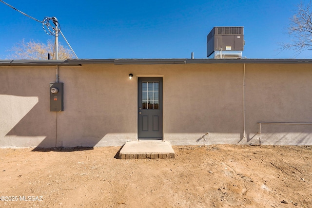 back of house featuring central AC unit