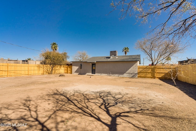 rear view of property featuring cooling unit