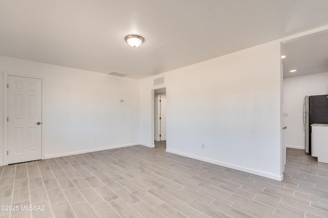 unfurnished room with light wood-type flooring