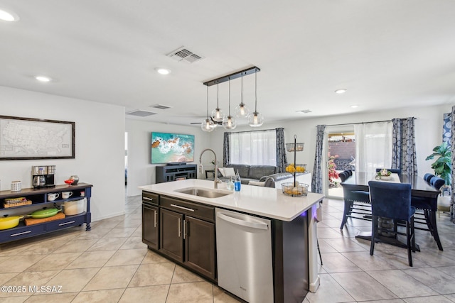 kitchen featuring a sink, visible vents, open floor plan, light countertops, and dishwasher