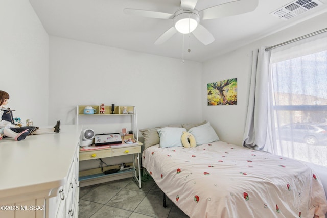 bedroom featuring visible vents, a ceiling fan, and light tile patterned flooring