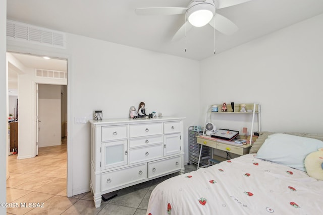 bedroom with a ceiling fan, visible vents, and light tile patterned floors