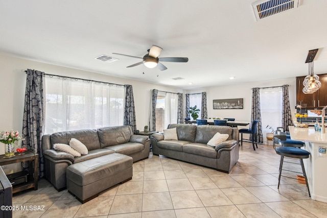 living room featuring visible vents, a ceiling fan, and light tile patterned flooring