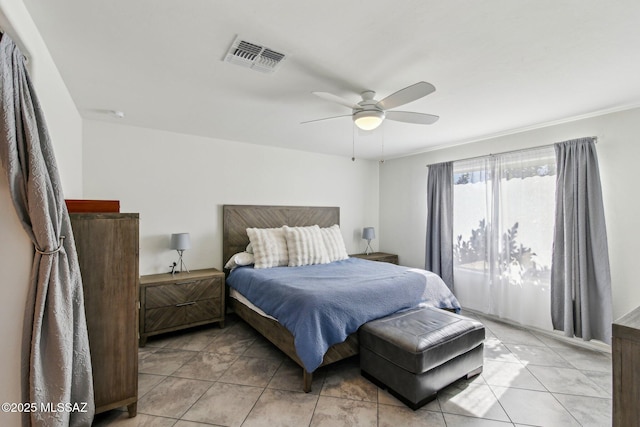 bedroom featuring visible vents, ceiling fan, and light tile patterned floors