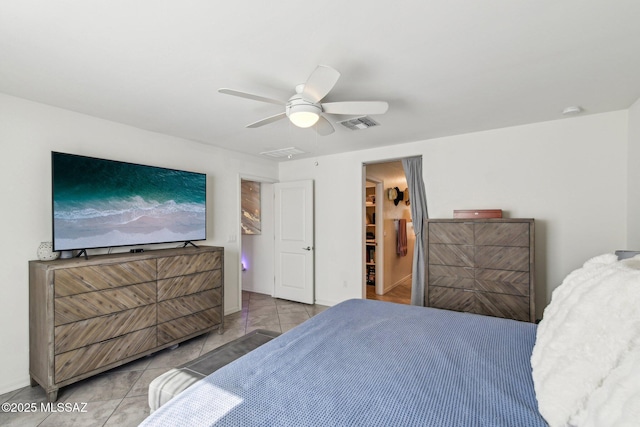 bedroom with a ceiling fan, visible vents, and baseboards