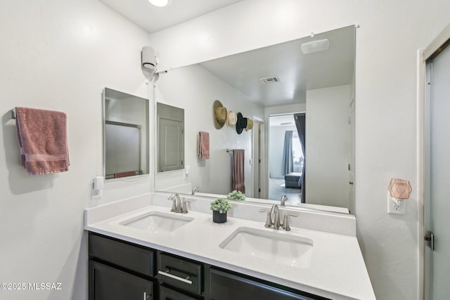 bathroom featuring double vanity, a sink, and visible vents