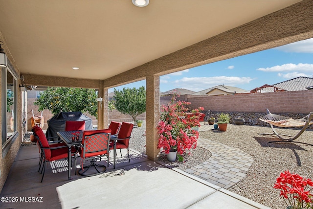 view of patio / terrace featuring outdoor dining area, grilling area, and a fenced backyard