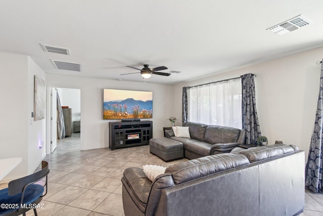 living area featuring ceiling fan and visible vents