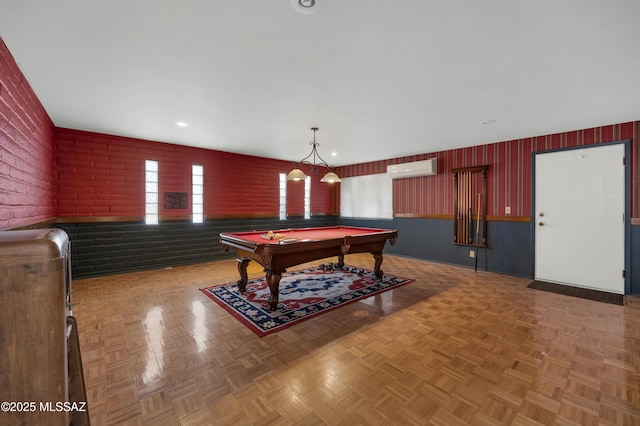 playroom featuring brick wall, parquet flooring, a wall mounted AC, and billiards