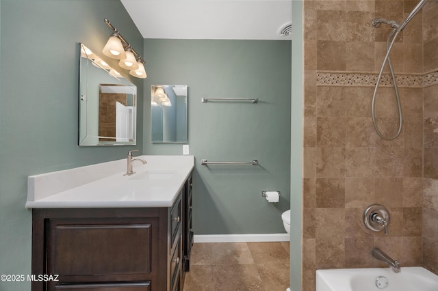 full bathroom featuring vanity, toilet, and tiled shower / bath