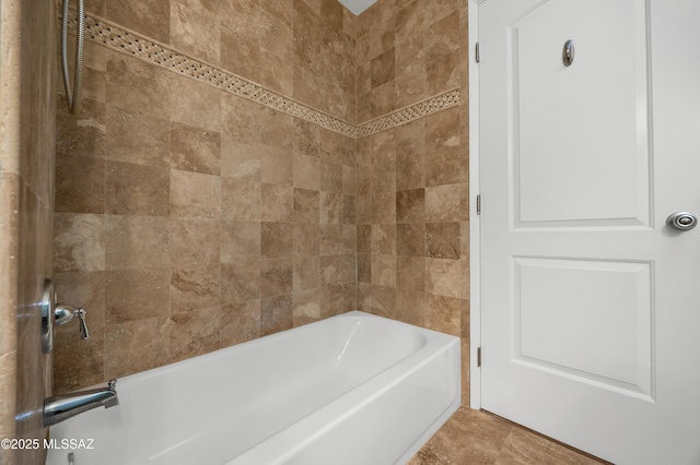 bathroom with tile patterned floors and bathtub / shower combination