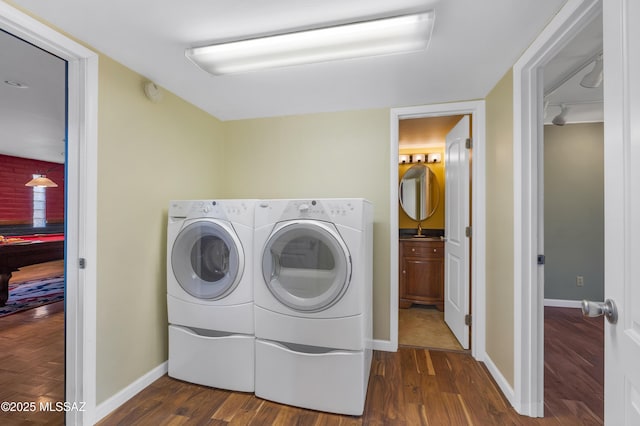 washroom with dark hardwood / wood-style floors and washer and dryer