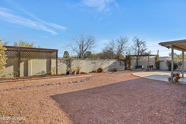 view of yard with a pergola and a patio area