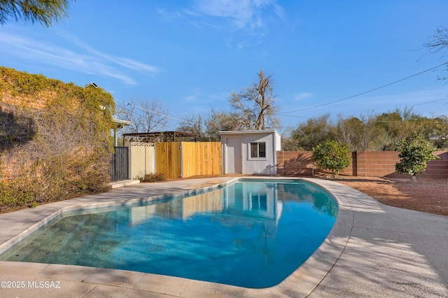 view of pool with a storage shed