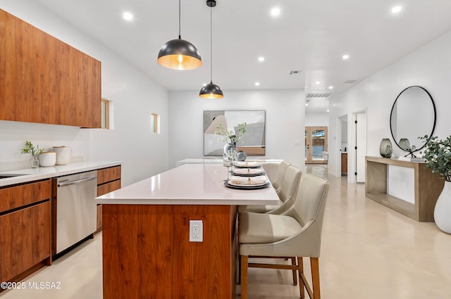 kitchen featuring hanging light fixtures, a kitchen island, stainless steel dishwasher, and a kitchen bar