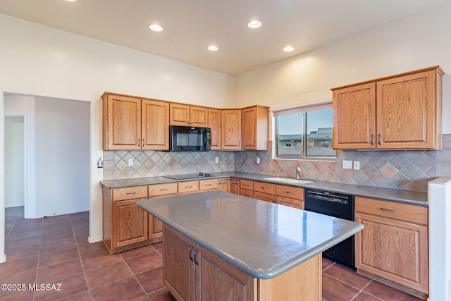 kitchen featuring dark tile patterned flooring, a sink, decorative backsplash, black appliances, and a center island