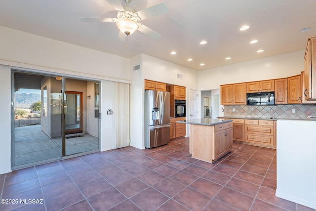 kitchen with black appliances, dark tile patterned floors, backsplash, a center island, and recessed lighting