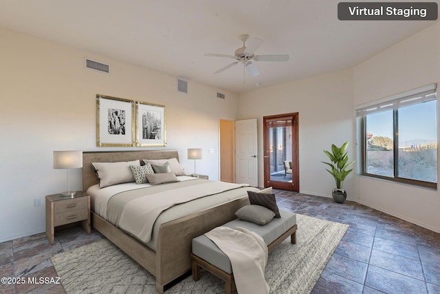 bedroom featuring stone finish floor, baseboards, and visible vents