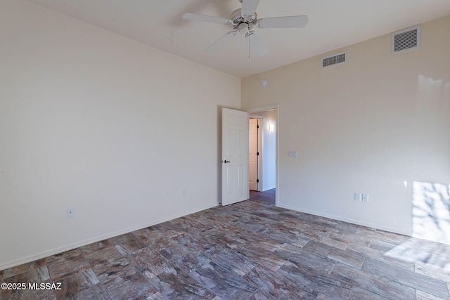 empty room with visible vents, baseboards, and a ceiling fan