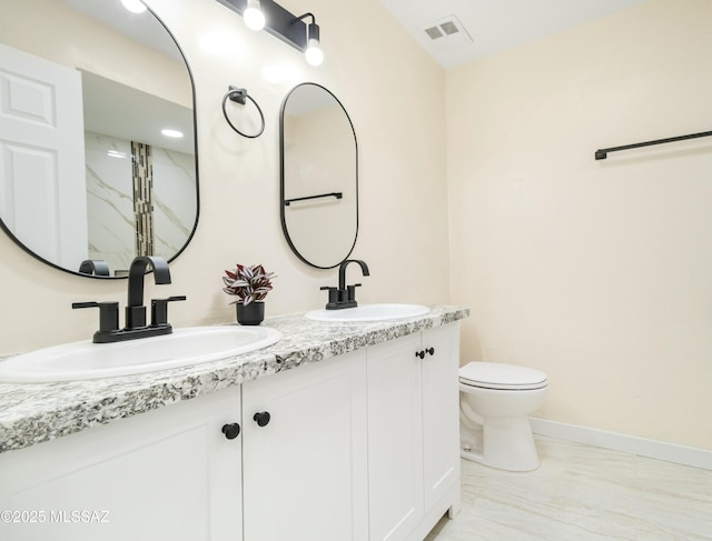 bathroom with vanity and toilet