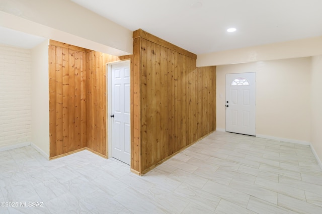 interior space featuring wooden walls