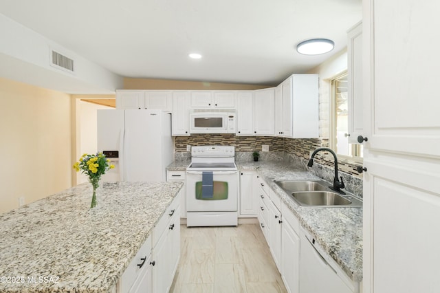 kitchen featuring white cabinetry, sink, white appliances, and tasteful backsplash