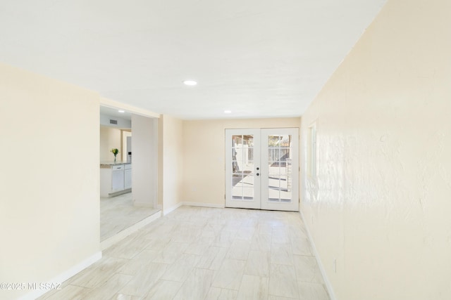 unfurnished room featuring french doors