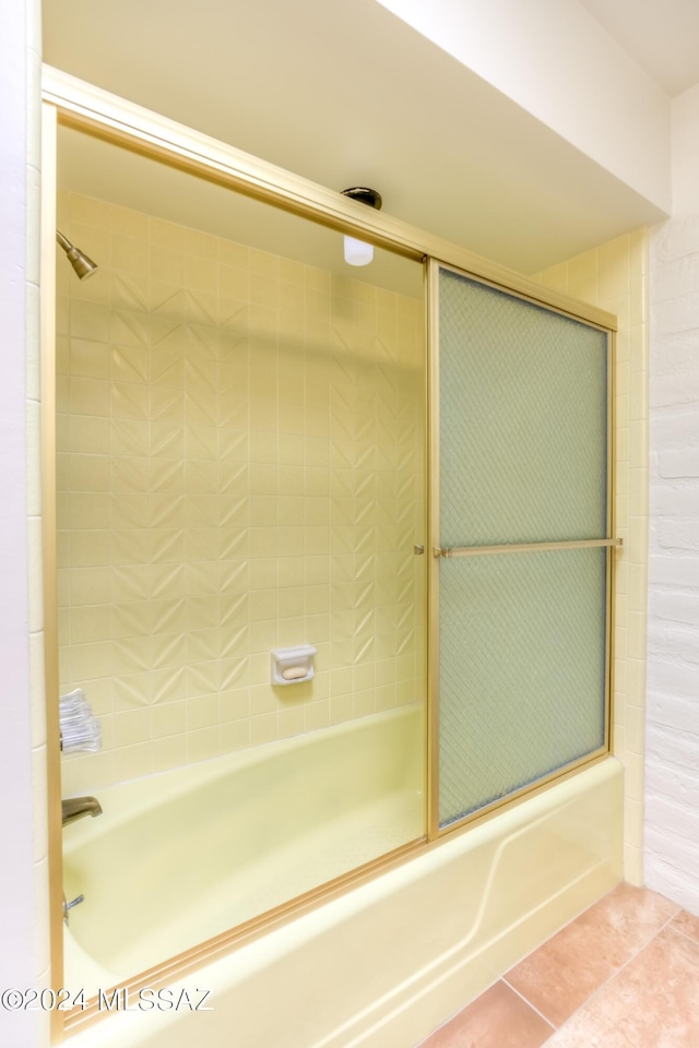 bathroom featuring tile patterned floors and bath / shower combo with glass door