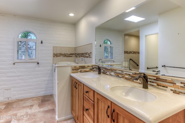 bathroom featuring tasteful backsplash, plenty of natural light, and vanity