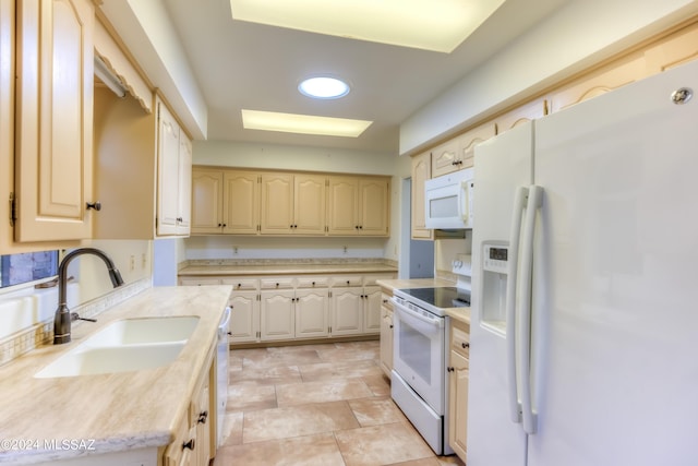 kitchen featuring white appliances and sink