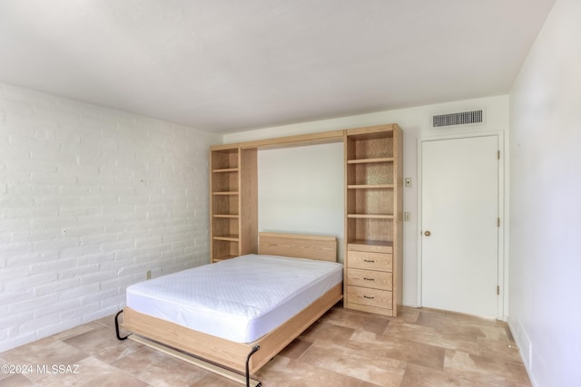 bedroom with brick wall