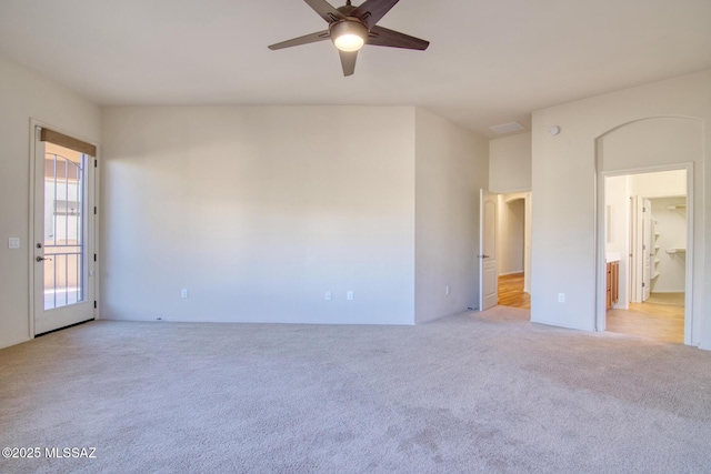 unfurnished room with ceiling fan and light carpet