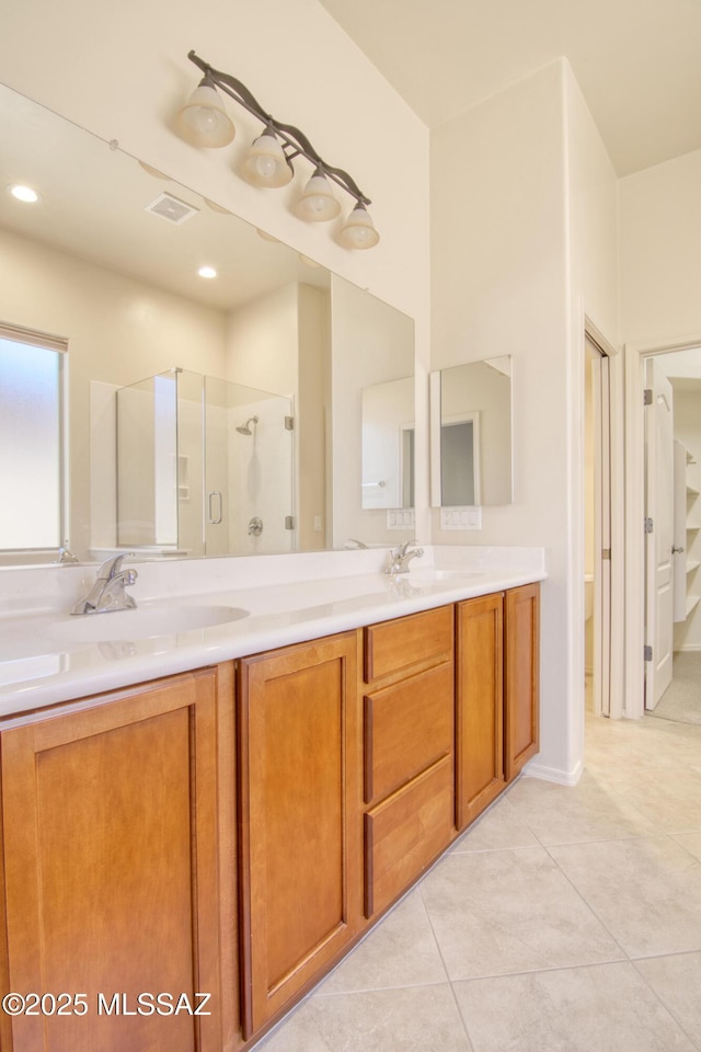 bathroom with walk in shower, tile patterned floors, and vanity