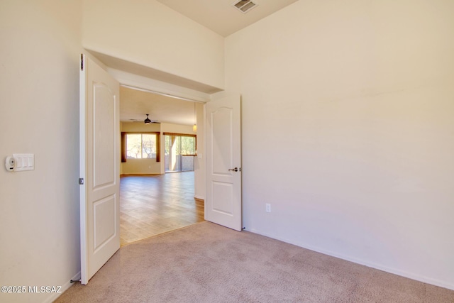 unfurnished room featuring light colored carpet