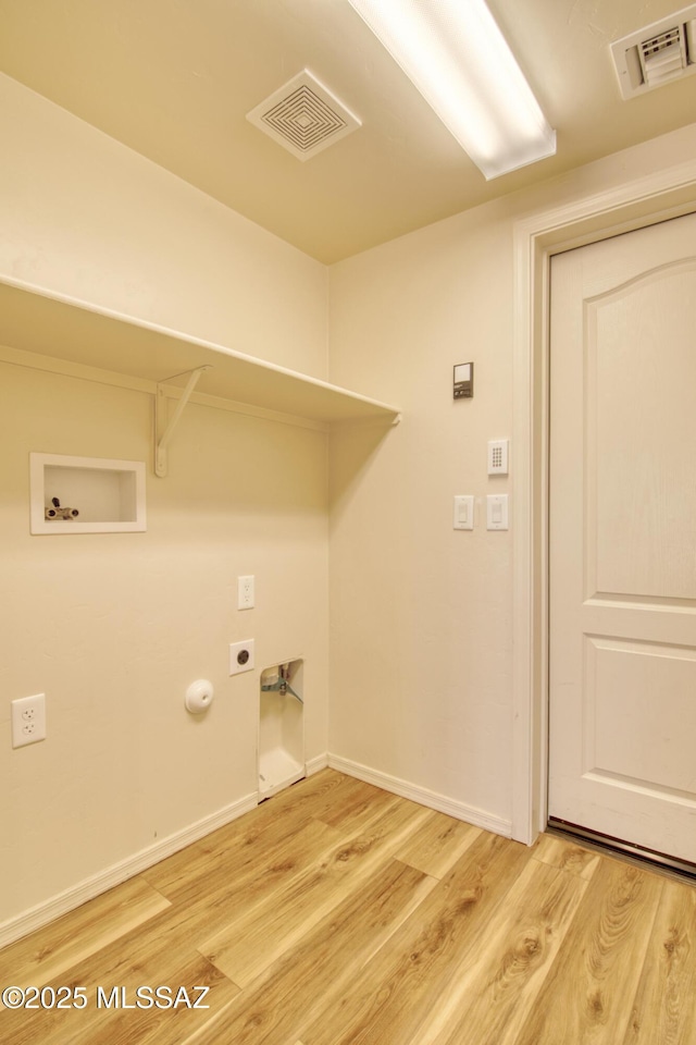 laundry room featuring hookup for a gas dryer, hookup for an electric dryer, washer hookup, and light wood-type flooring