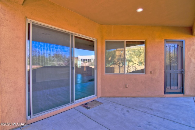 view of exterior entry featuring a patio area