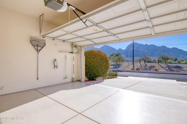 garage featuring a garage door opener and a mountain view