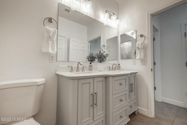 bathroom featuring vanity, tile patterned flooring, and toilet