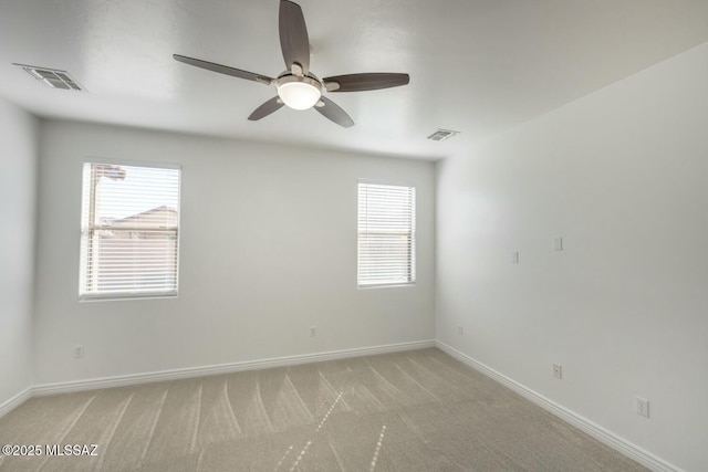 spare room featuring ceiling fan and light colored carpet