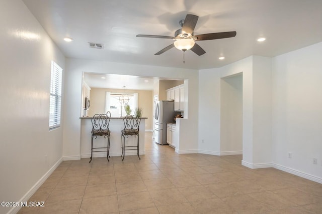 tiled empty room with ceiling fan